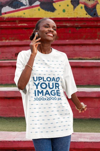 Oversized Tee Mockup of a Joyful Woman Dancing in the Street With a Happy Expression