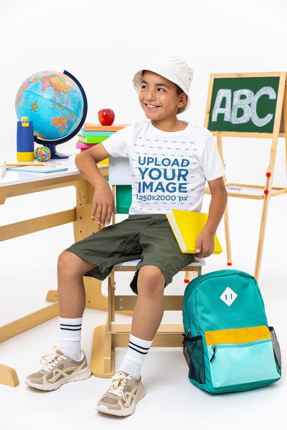 Bella Canvas T-Shirt Mockup Featuring a Happy Boy in a Classroom-Themed Setting