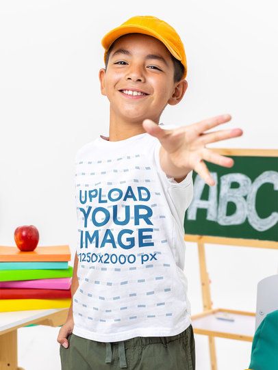 Bella Canvas T-Shirt Mockup Featuring a Joyful Boy Posing in a School Classroom Set