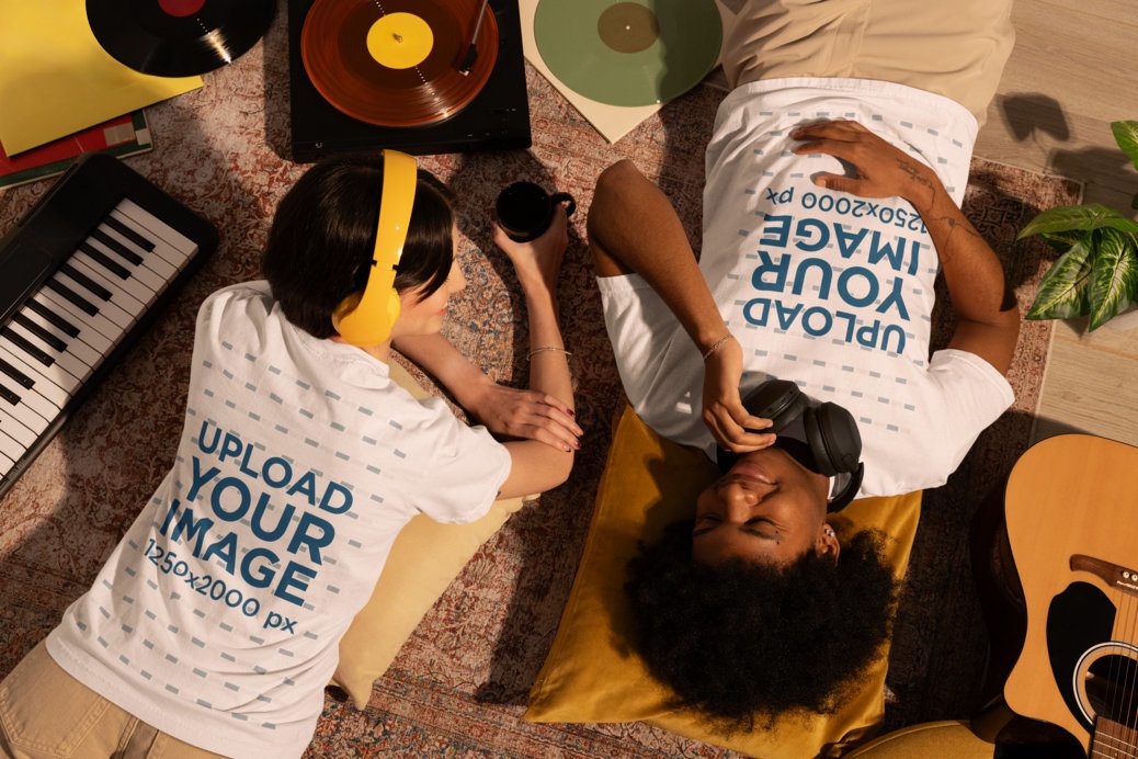 Comfort Colors T-Shirt Mockup Featuring a Happy Couple Lying on the Floor Listening to Music