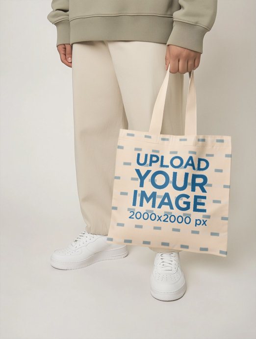 Tote Bag Mockup Featuring an AI-Created Person Standing in a Studio