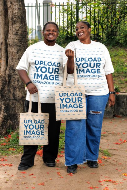 Oversized Tee Mockup Featuring a Cheerful Man With a Woman Carrying Tote Bags in a Park