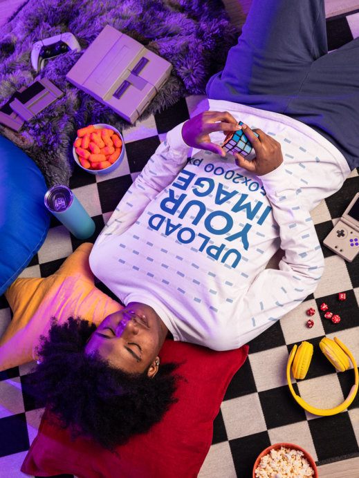 Comfort Colors Long-Sleeve Tee Mockup Featuring a Man Resting and Playing With a Rubik's Cube