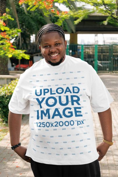 Oversized T-Shirt Mockup of a Happy Bearded Man Posing in a Park