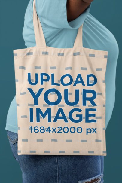 Tote Bag Mockup Featuring a Cropped-Face Woman Standing Against a Colorful Wall