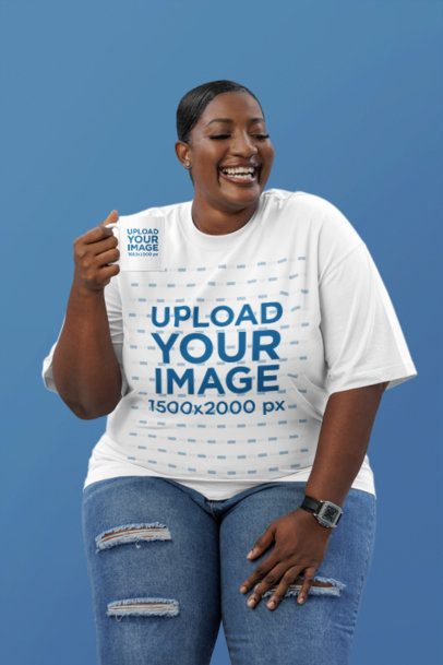 Oversized T-Shirt Mockup Featuring a Happy Woman With a Coffee Mug in a Studio