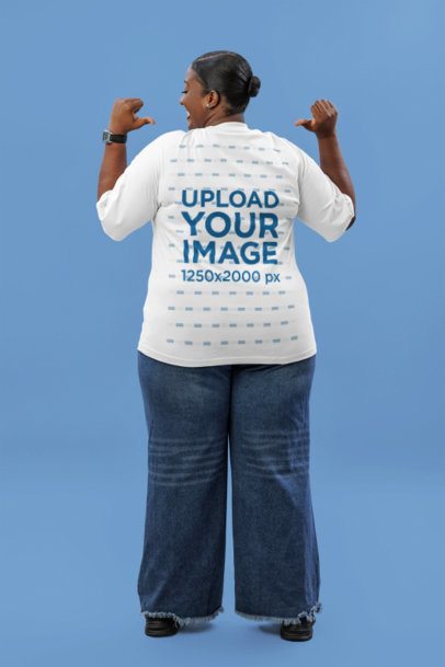 Back-View Mockup Featuring a Woman Pointing at Her Oversized Tee in a Studio