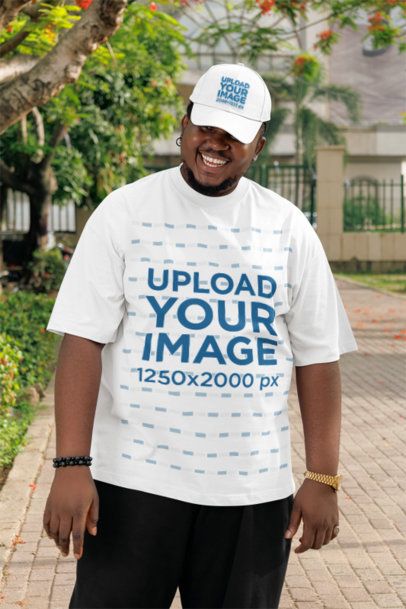 Dad Hat Mockup of a Smiling Bearded Man in an Oversized T-Shirt Walking in a Park