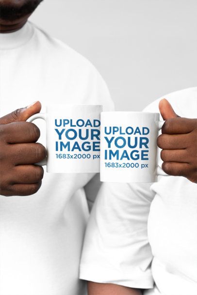 Mockup of a Man and a Woman Posing With Coffee Mugs in a Studio