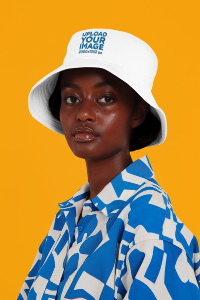 Embroidered Bucket Hat Mockup of an AI-Generated Woman Posing in a Studio Setting