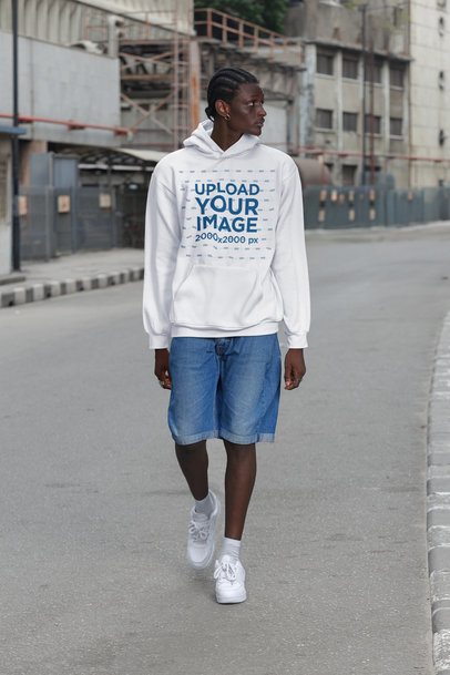 Hoodie Mockup of a Serious Man Walking on the Street With an Urban Stylish Look