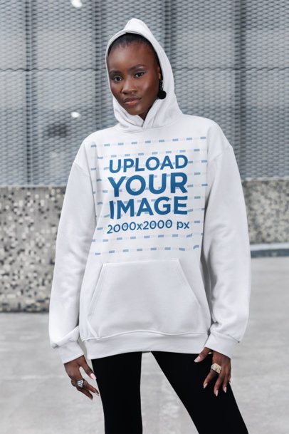 Hoodie Mockup of a Woman Standing on the Sidewalk With a Serious Pose