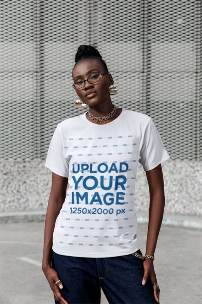 Round-Neck Tee Mockup of a Woman Standing With a Serious Expression in the Street