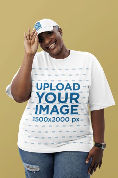 Oversized T-Shirt Mockup of a Joyful Woman Wearing an Embroidered Dad Hat Posing in a Studio