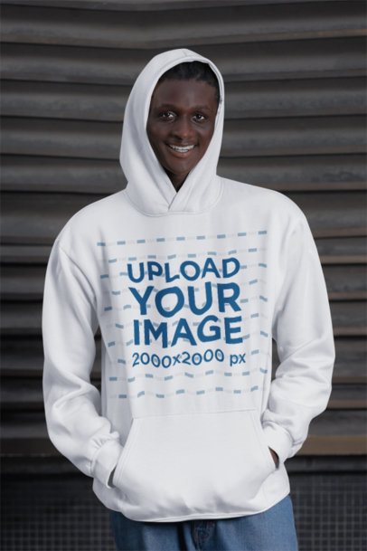 Hoodie Mockup Featuring a Smiling Man With Jeans Posing in the Street