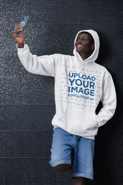 Hoodie Mockup Featuring a Happy Man Taking a Selfie With a Smartphone