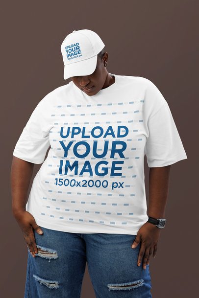 Oversized Tee Mockup Featuring a Woman Wearing a Dad Hat Posing Against a Colorful Wall