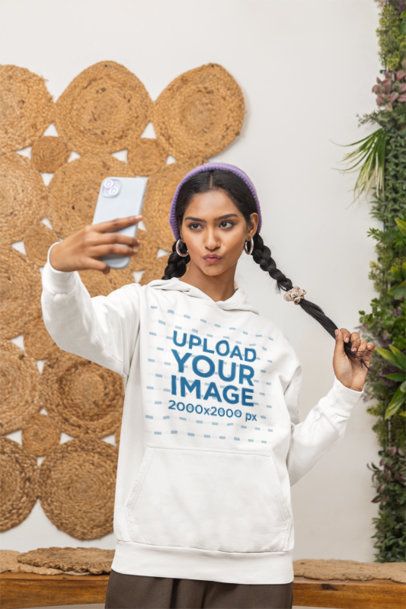 Pullover Hoodie Mockup of a Woman Making a Duckface While Taking a Selfie m55432