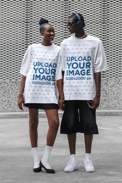 Oversized T-Shirt Mockup of a Happy Woman Holding Hands With a Man on the Street