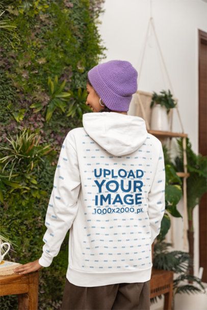Back-View Hoodie Mockup of a Woman Posing in a Cozy Room With Plants m55437