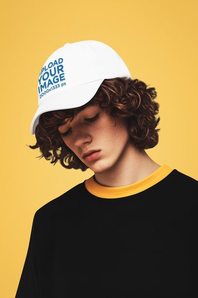 Embroidered Dad Hat Mockup of an AI-Generated Young Man With Curly Hair Posing in a Studio
