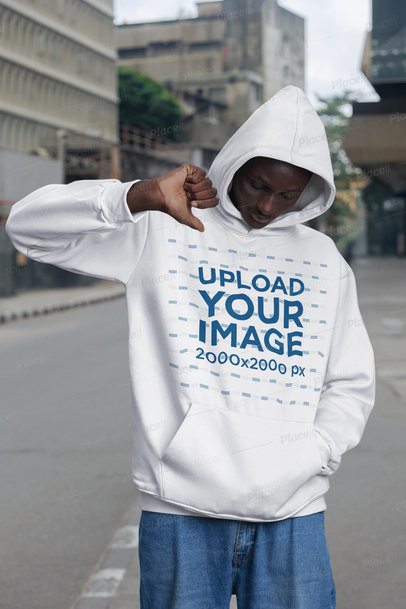 Mockup Featuring a Serious Man Pointing at His Pullover Hoodie in the Street