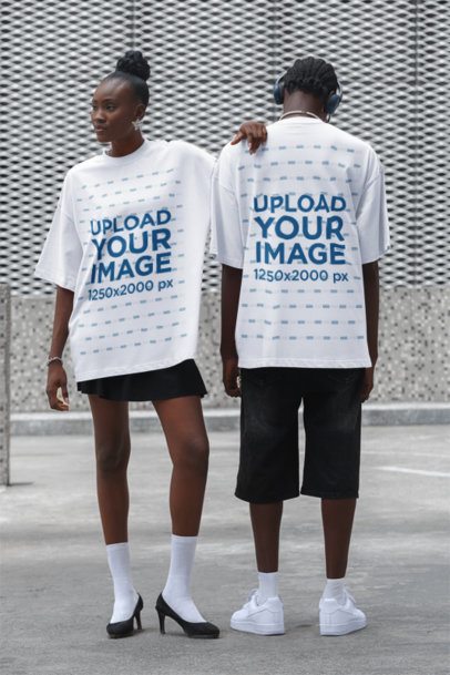 Oversized T-Shirt Mockup Featuring a Serious Woman and a Man Standing in the Street