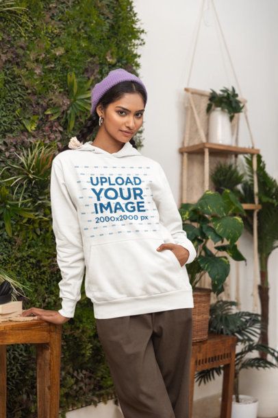 Pullover Hoodie Mockup Featuring a Woman Posing in a Cozy Setting With Plants m55430