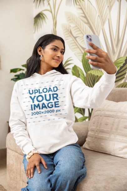 Pullover Hoodie Mockup of a Woman Taking a Selfie While Posing in a Living Room m55446