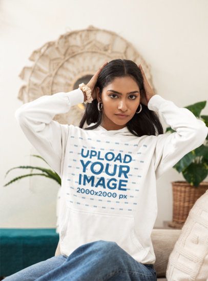 Hoodie Mockup Featuring a Serious Woman Sitting on a Cozy Couch in a Living Room m55445