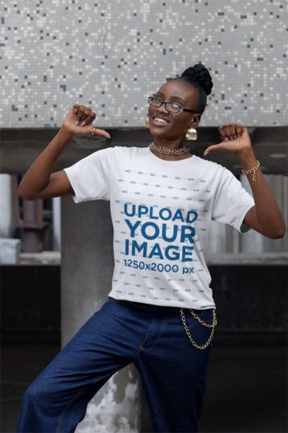 Mockup Featuring a Cheerful Woman Pointing at Her Round-Neck T-Shirt on the Sidewalk