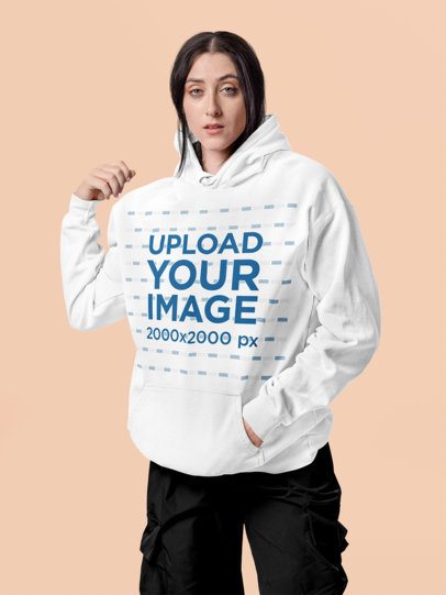 Comfort Colors Hoodie Mockup Featuring a Woman Posing in a Colorful Setting With a Serious Look m57416