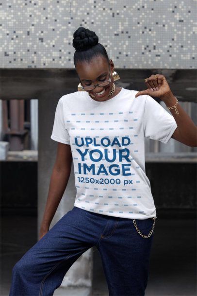 Mockup Featuring a Joyful Woman Pointing at Her Round-Neck T-Shirt in the Street