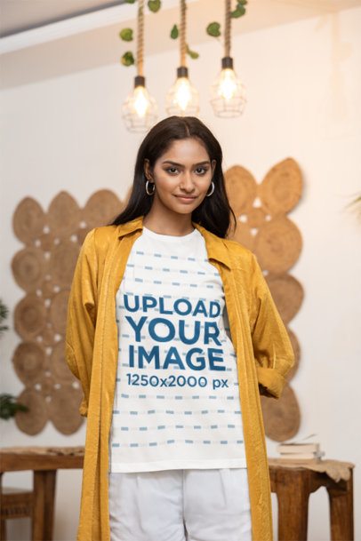 T-Shirt Mockup of a Woman Posing With a Smiling Look in a Cozy Home Setting m55411