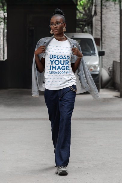 Round-Neck T-Shirt Mockup of a Serious Woman Walking by an Urban Setting