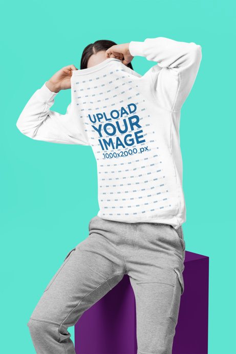 Comfort Colors Sweatshirt Mockup Featuring a Woman Covering Her Face in the Studio