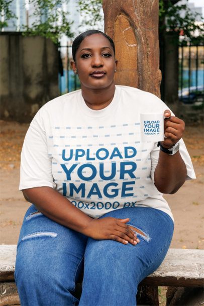 Oversized T-Shirt Mockup Featuring a Serious Woman Sitting on a Bench With a Coffee Mug