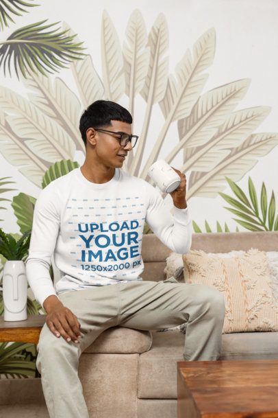 Sweatshirt Mockup of a Man With Glasses Sitting on a Nice Cozy Couch m55370