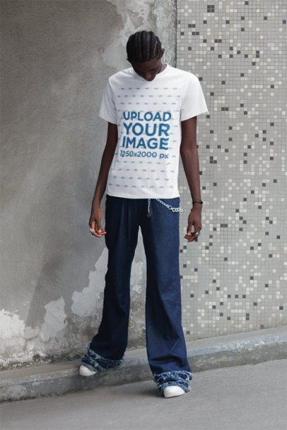 T-Shirt Mockup of a Man Posing in the Street While Looking Down