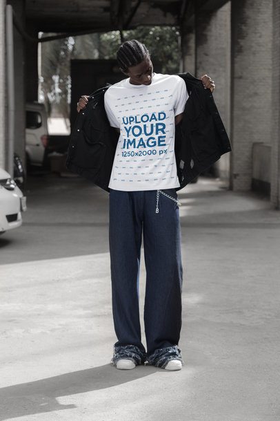 T-Shirt Mockup Featuring a Man Taking Off His Jacket in a Parking Lot m55886
