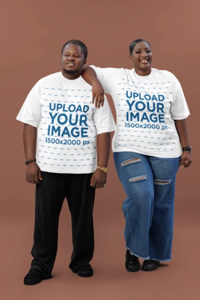 Oversized T-Shirt Mockup of a Smiling Woman Posing Next to a Man in a Studio
