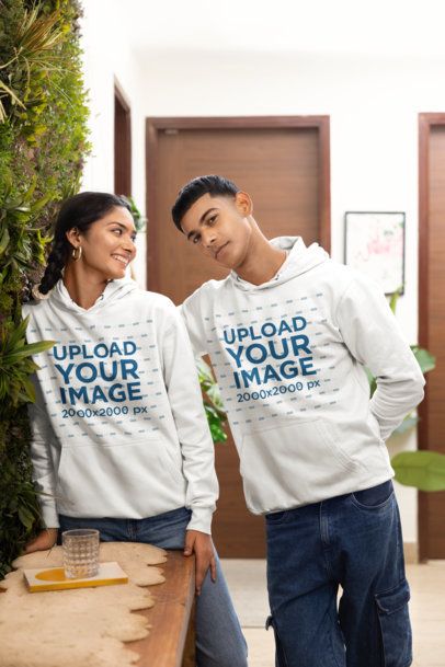 Hoodie Mockup of a Smiling Woman Looking at a Man in a Cozy Room m55443