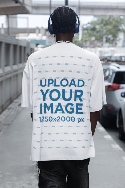 Back-View Mockup Featuring a Man in an Oversized T-Shirt Walking in the Street