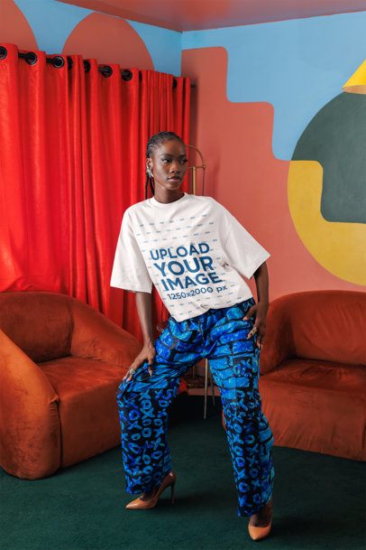 Oversized T-Shirt Mockup of a Stylish Woman Posing in a Colorful Living Room