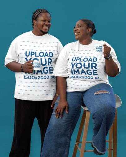 Coffee Mug Mockup Featuring a Cheerful Man and a Woman Wearing Oversized Tees in a Studio