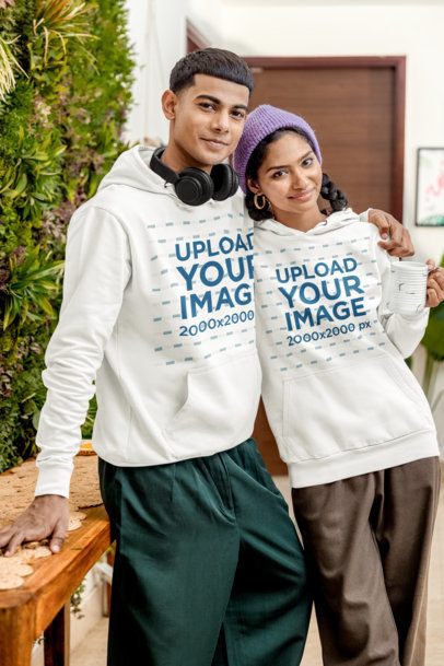 Hoodie Mockup Featuring a Smiling Man Hugging a Happy Woman in a Cozy Room m55438