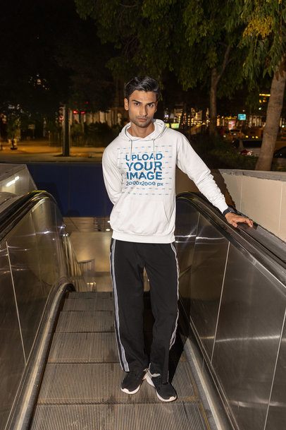 Pullover Hoodie Mockup of a Man Posing on an Escalator at Night m56873