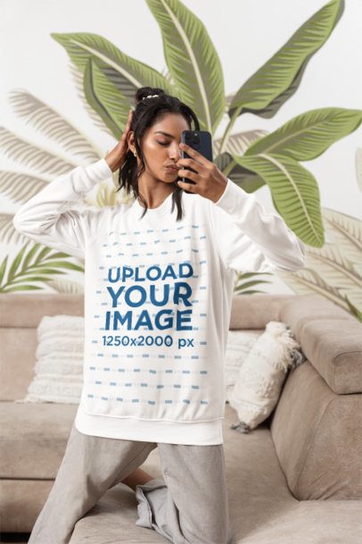 Sweatshirt Mockup of a Woman Posing for a Selfie in a Cozy Living Room m55375