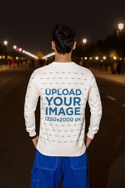 Back-View Sweatshirt Mockup Featuring a Man Standing in the Street at Night m56830