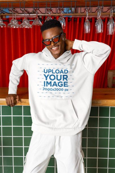 Pullover Hoodie Mockup Featuring a Happy Cool Man Posing in a Bar
